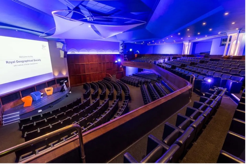 Modern auditorium interior with tiered seating and presentation stage